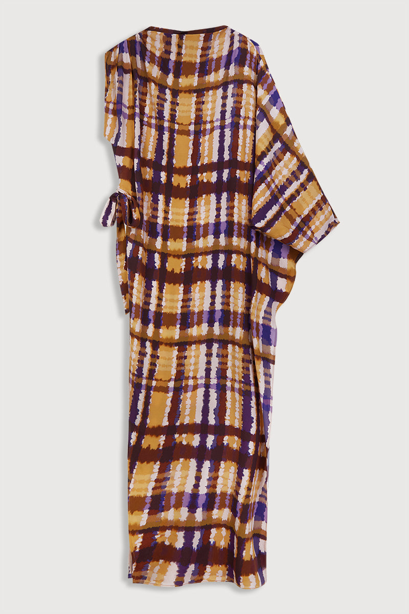 Blusón largo asimétrico de una manga estampado. Tiene lazo en el lateral para ajustar a la cintura.