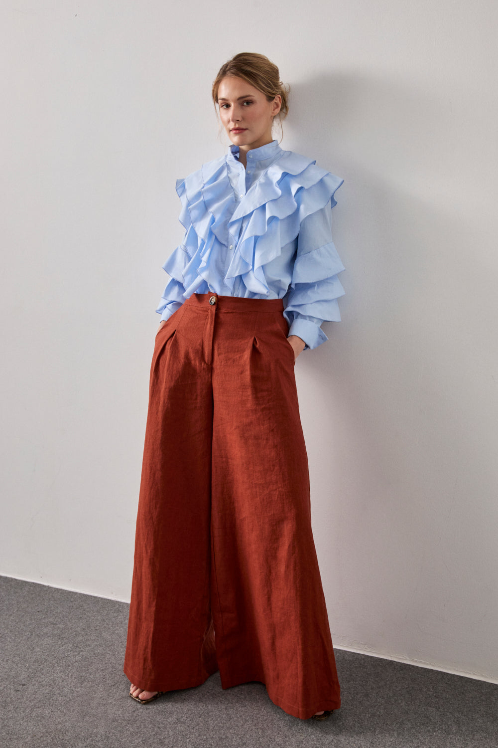 Camisa celeste de manga larga con volante en pecho y espalda. 